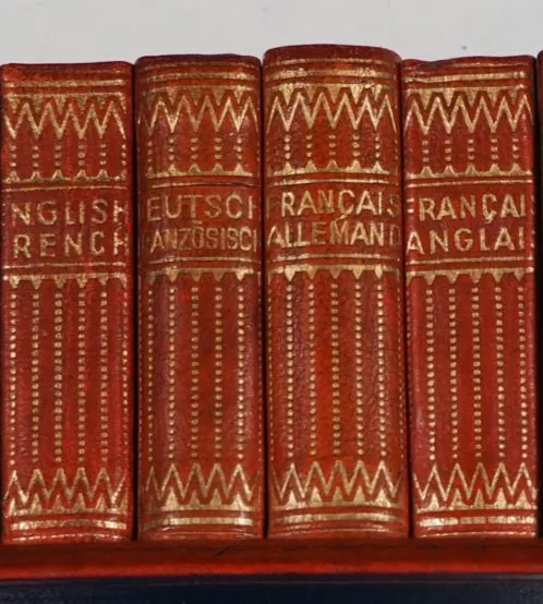ATTRACTIVE DESK SET OF FOUR LEATHER-BOUND LILLIPUT DICTIONARIES (ENGLISH, FRENCH AND GERMAN). BY PROF. WERSHOVEN. >>MINIATURE BOOK<<
