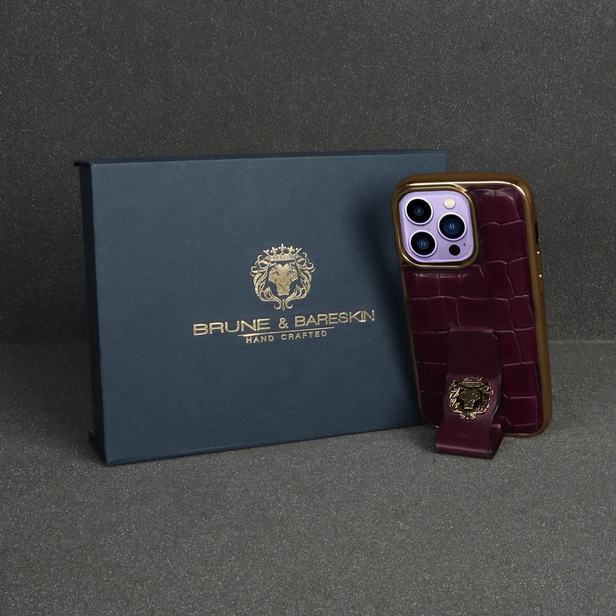 Purple iPhone Series Mobile Cover Golden Rim Finger strap cum Stand Croco Print Leather with Metal Lion Logo by Brune & Bareskin